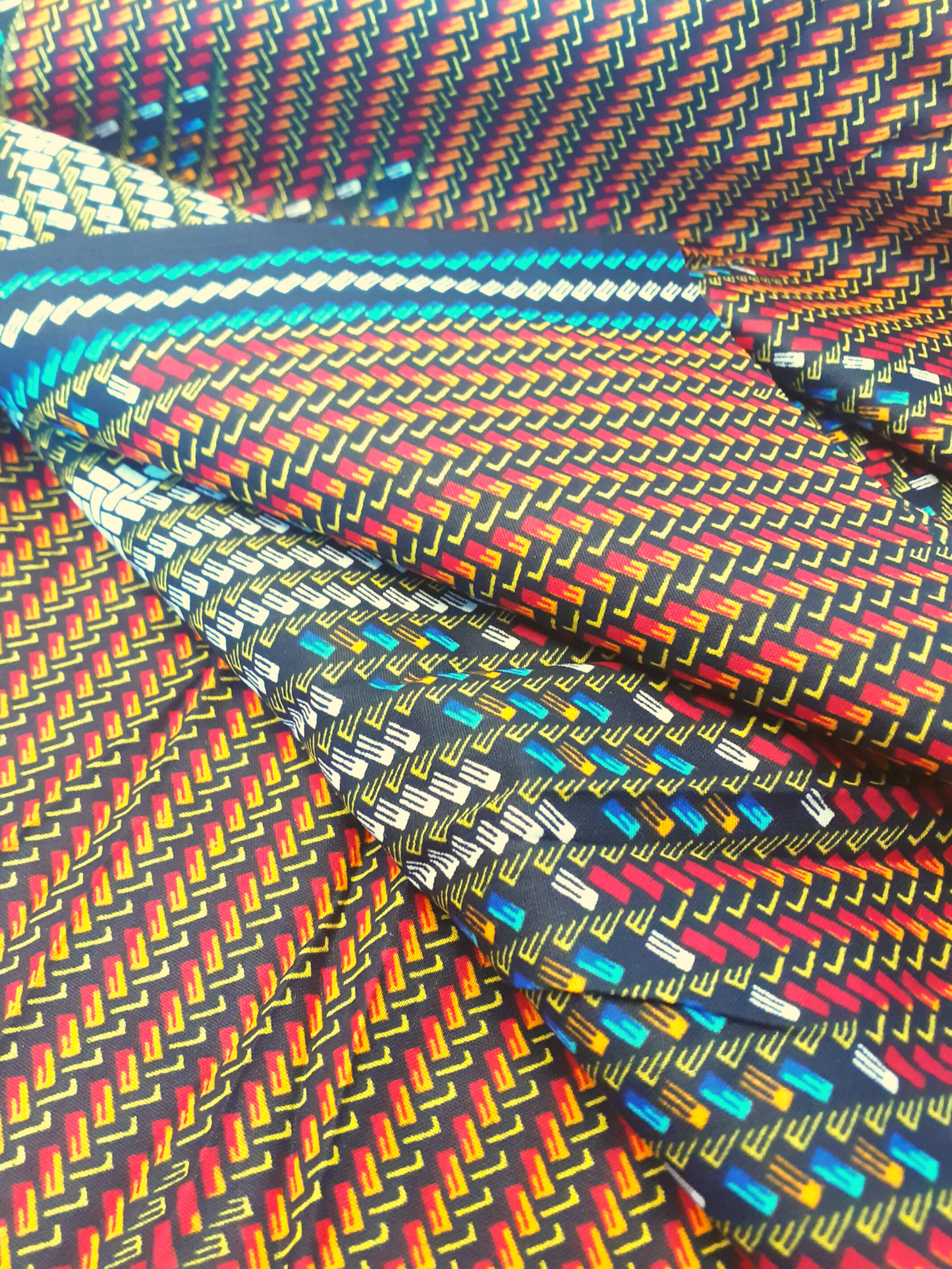 African Fabrics By the Yard - Kitenge - Basket Weaving Pattern. Red, Black, Blue, White, Yellow, and Orange